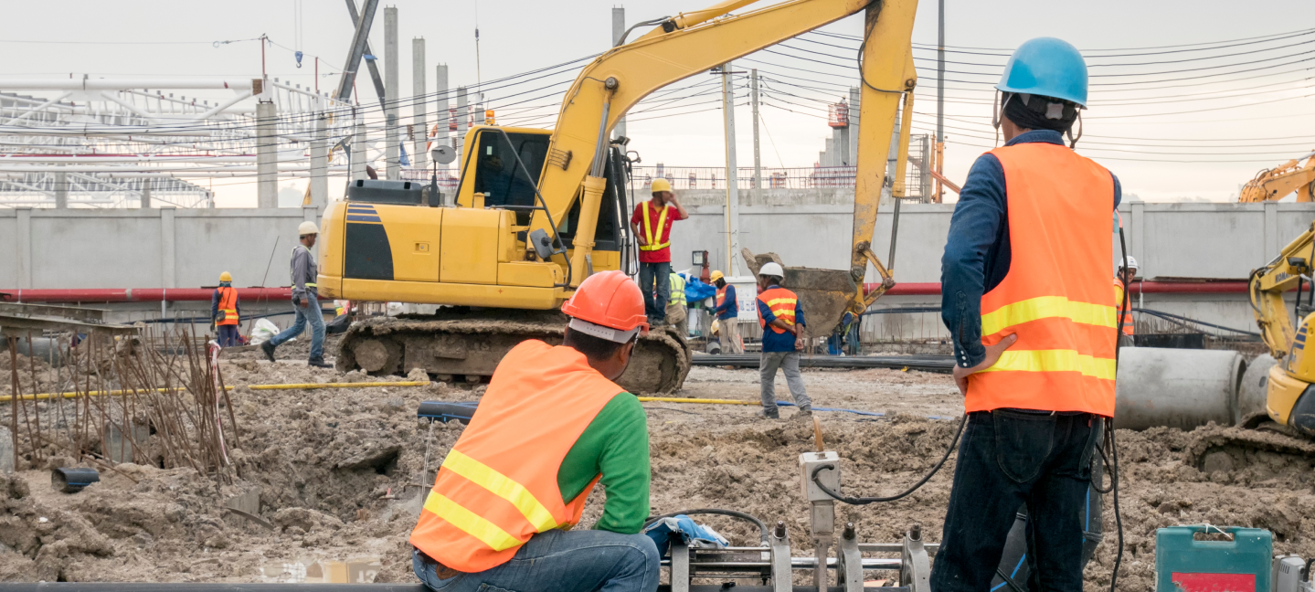 Construction worker connecting pipes